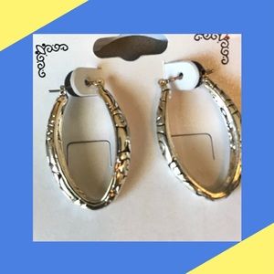 New. Oval silver tone hoops